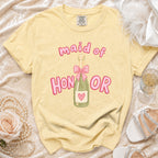 Yellow t-shirt with pink "maid of honor" text and champagne bottle graphic.