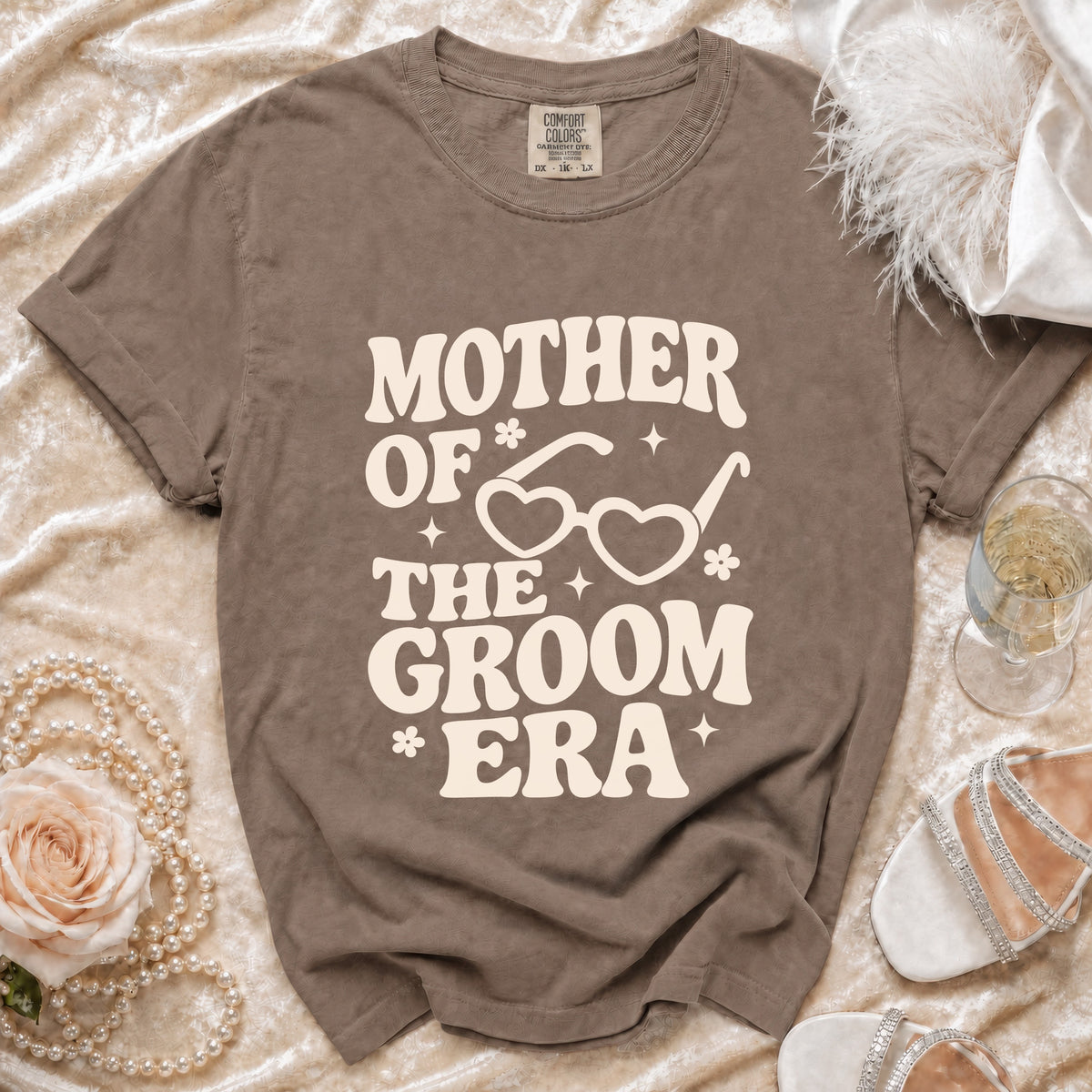 Brown t-shirt with "Mother of the Groom Era" text and heart-shaped glasses graphic.