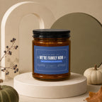 Glass candle with blue label reading "We're Family Now" for mom.