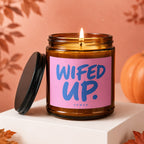 Amber jar candle with pink label that says "WIFED UP."