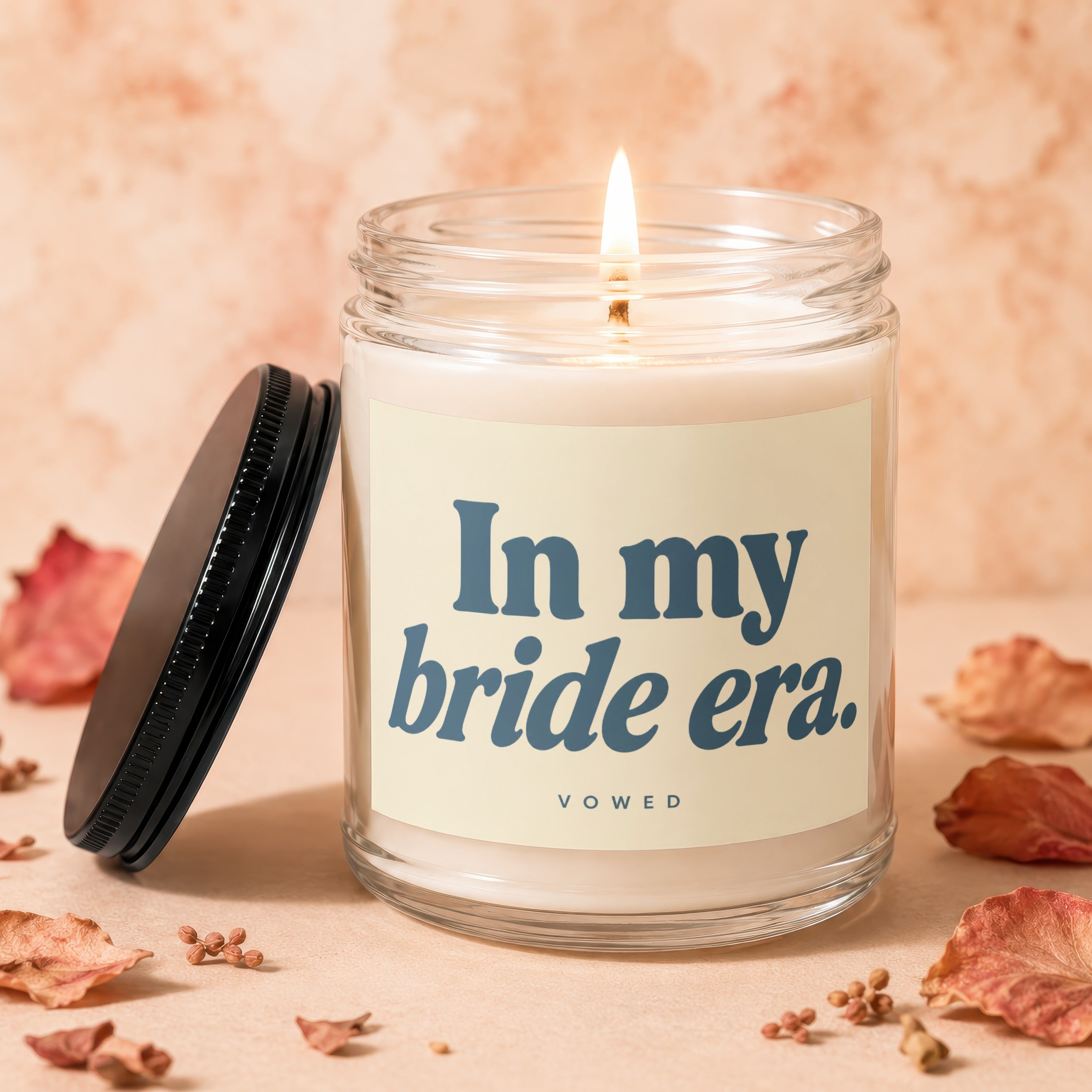 Candle with lit wick and label reading "In my bride era. VOWED".