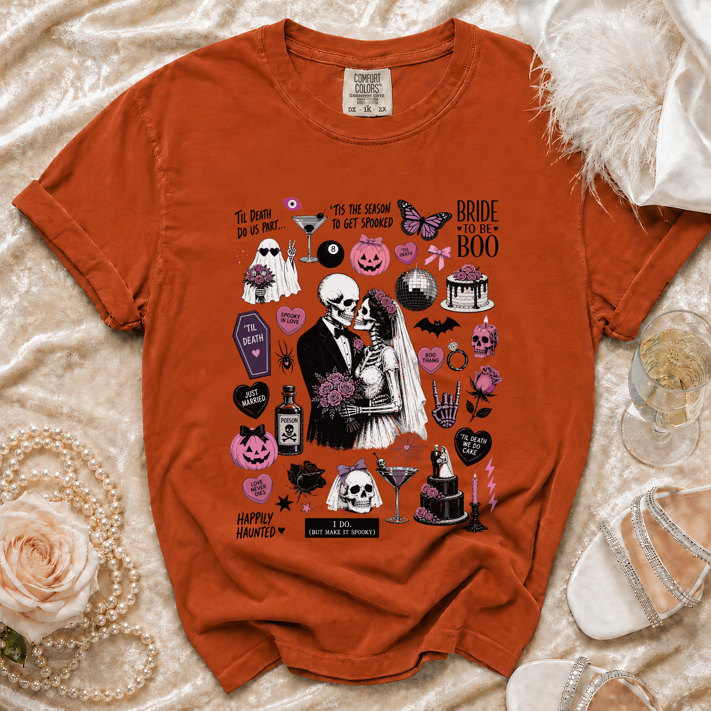 Orange t-shirt with Halloween bride and groom skeletons, ghosts, and pumpkins.