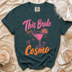 Dark green t-shirt with "This Bride Needs a Cosmo" text and cocktail graphic.