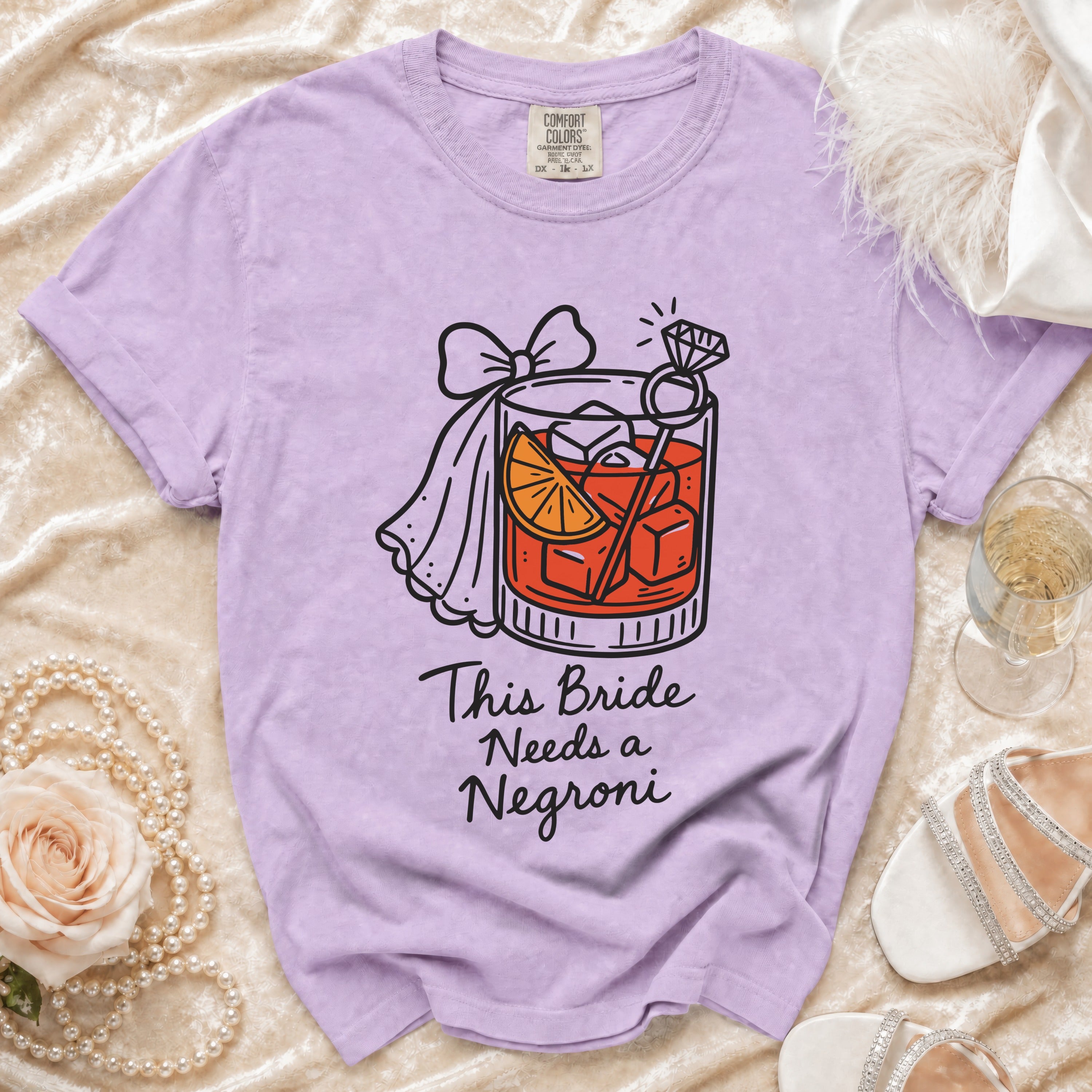 Purple t-shirt with "This Bride Needs a Negroni" text and cocktail graphic.