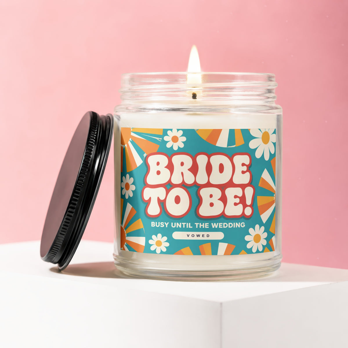 "Bride to Be" candle with a retro floral design and text "VOWED".