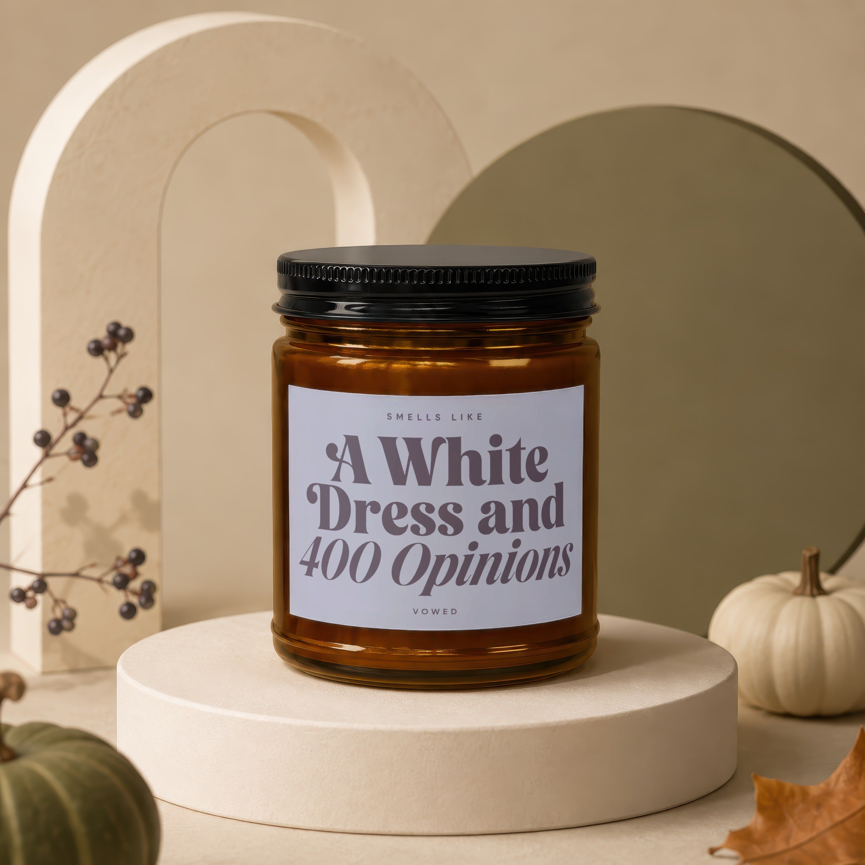Amber jar candle with black lid reading "Smells Like A White Dress and 400 Opinions".