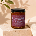 Candle reads "I Survived My Son's Wedding" with notes of pride, panic, and open bar.