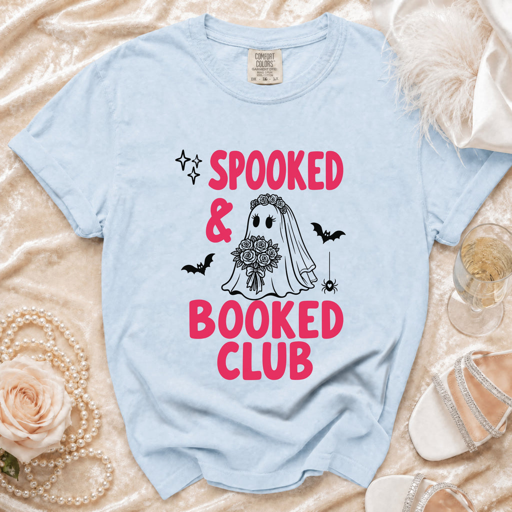 Light blue t-shirt with "Spooked & Booked Club" graphic and a ghost bride design.