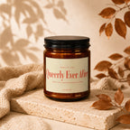 Amber jar candle labeled "Queerly Ever After" with vow collection detail.