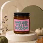 Candle with pink label reading "Vows, Veils & Very Bad Decisions".