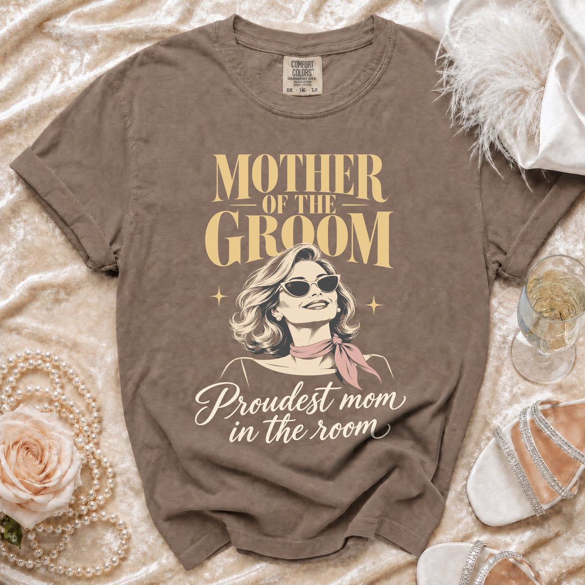 Brown t-shirt with "Mother of the Groom" and "Proudest mom in the room" text.