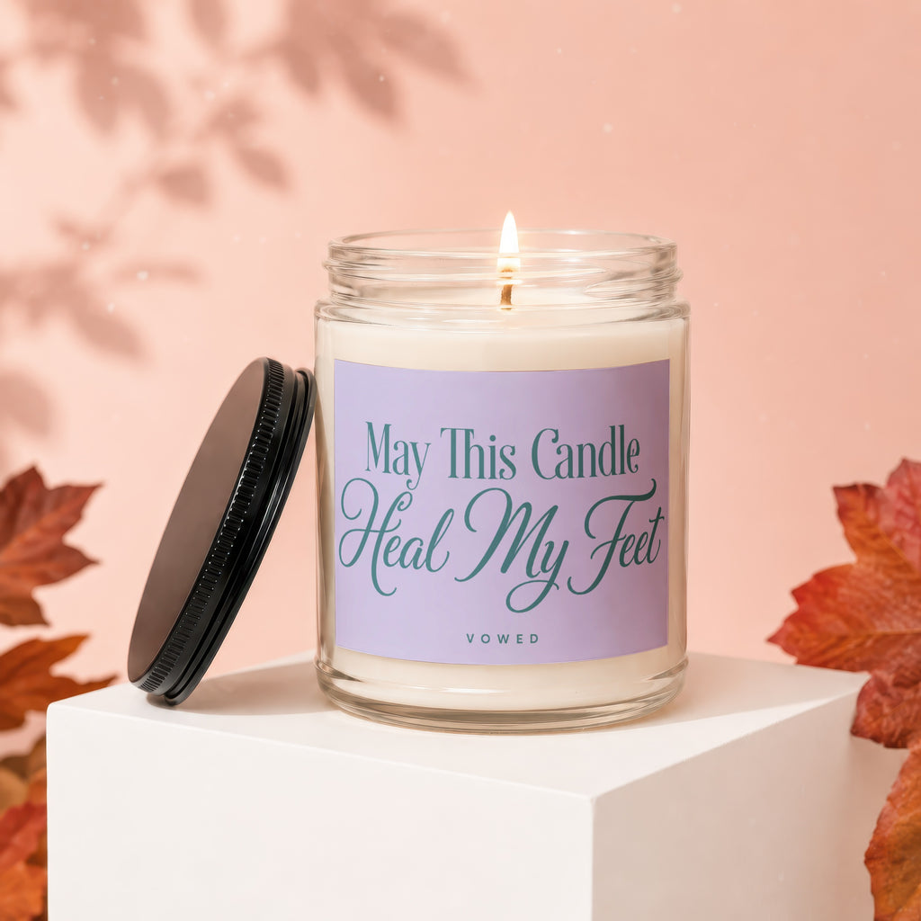Candle with text "May This Candle Heal My Feet" on a light purple label.