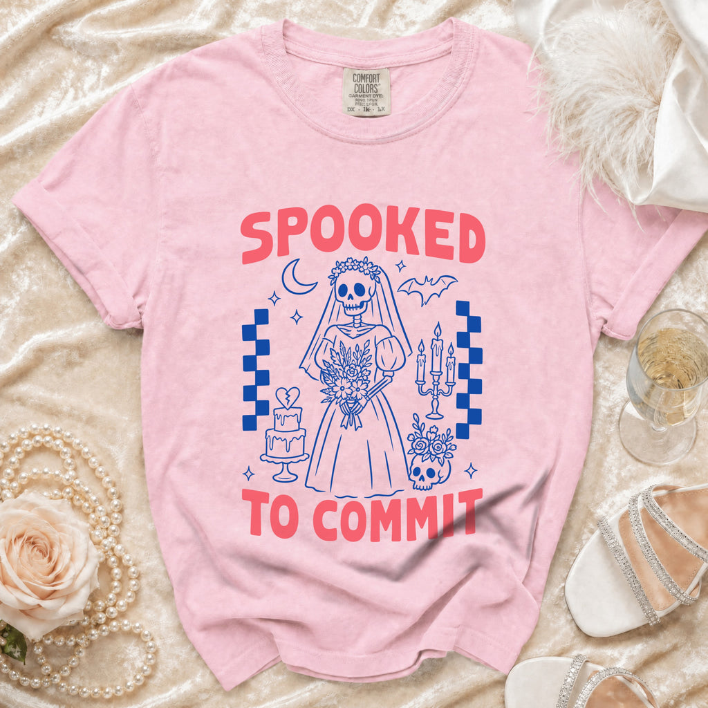 Pink t-shirt with "SPOOKED TO COMMIT" text and skeleton bride graphic.