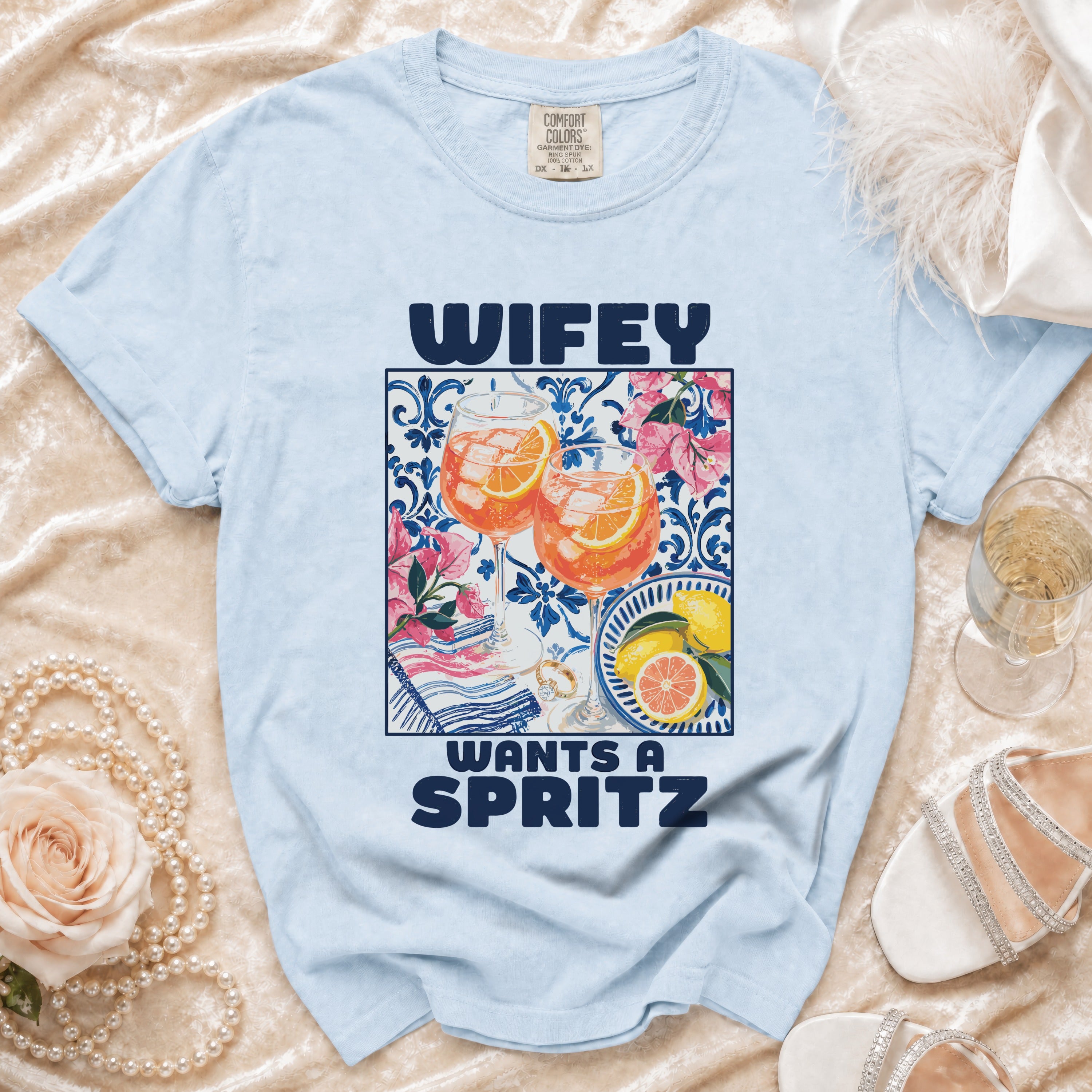 Light blue t-shirt with the text "WIFEY WANTS A SPRITZ" and a graphic of two spritz drinks.