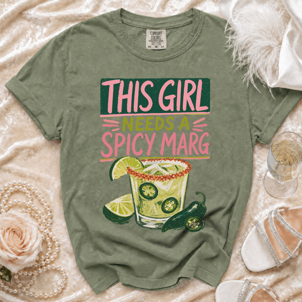 Green t-shirt with "This girl needs a spicy marg" text and margarita graphic.