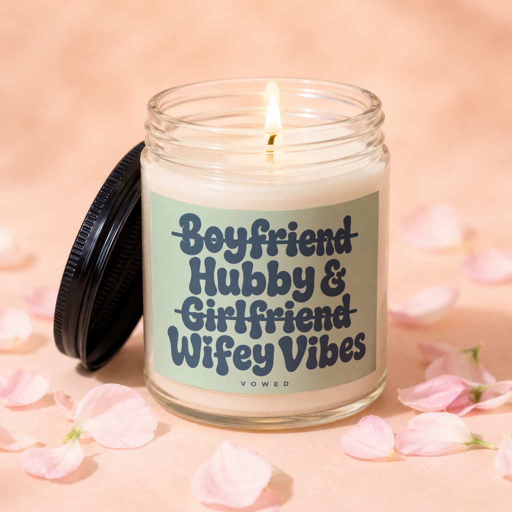 Jar candle with text "Boyfriend Hubby & Girlfriend Wifey Vibes" and a burning wick.