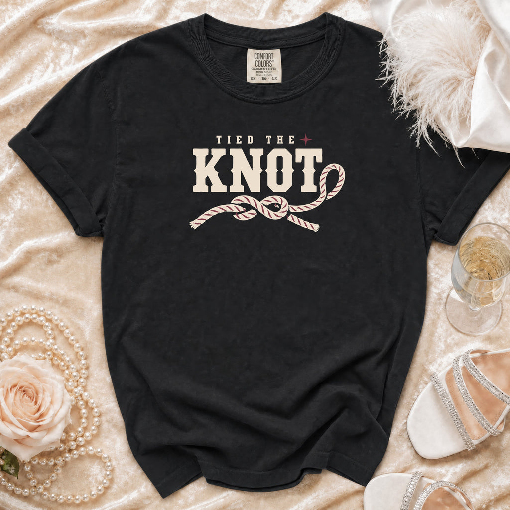 Black t-shirt with "Tied the Knot" text and rope knot graphic.
