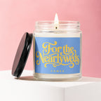 Candle with blue label saying "For the Nearlyweds" and "VOWED" on a pink background.
