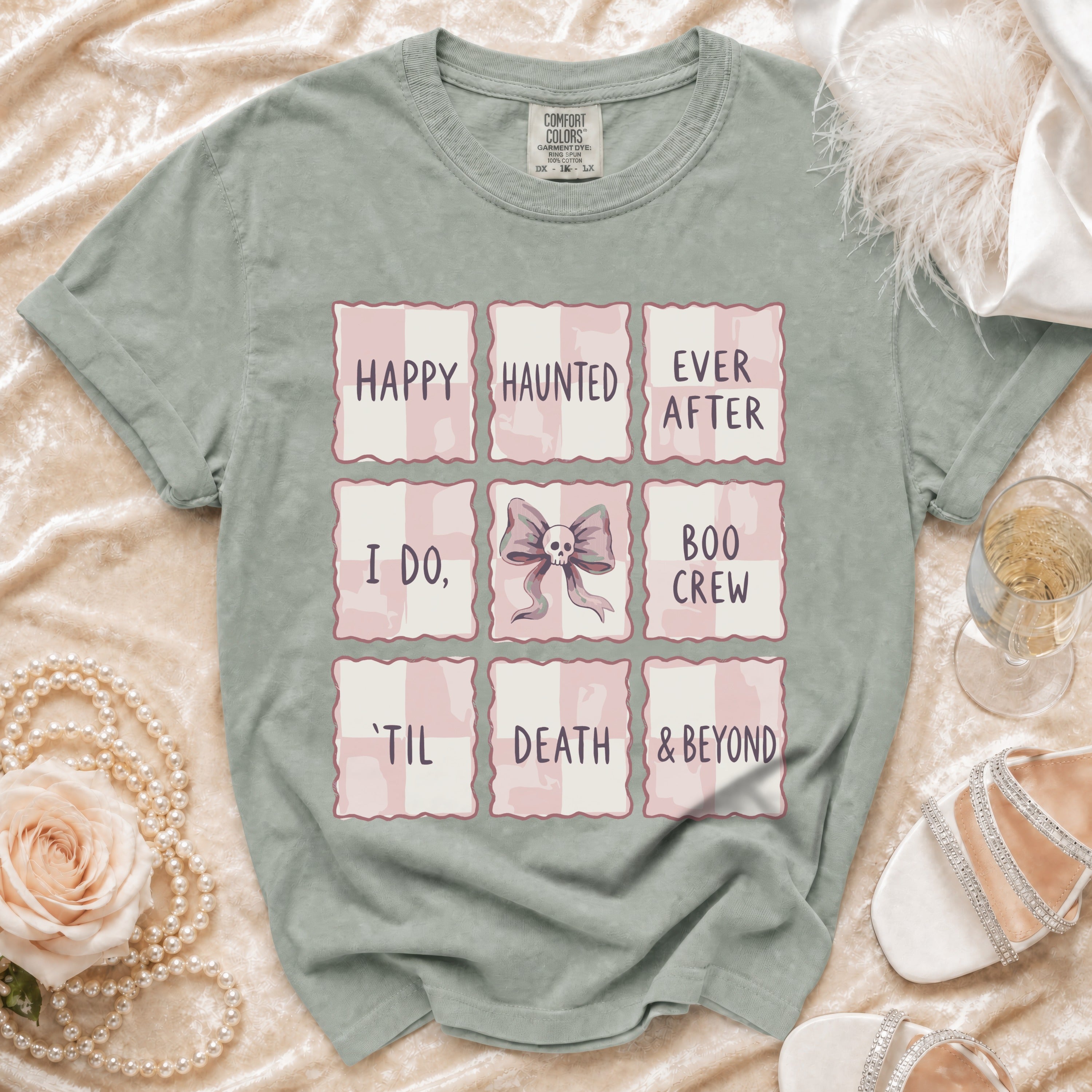 T-shirt with "Happy Haunted Ever After, I Do, Boo Crew, 'Til Death & Beyond" grid design.