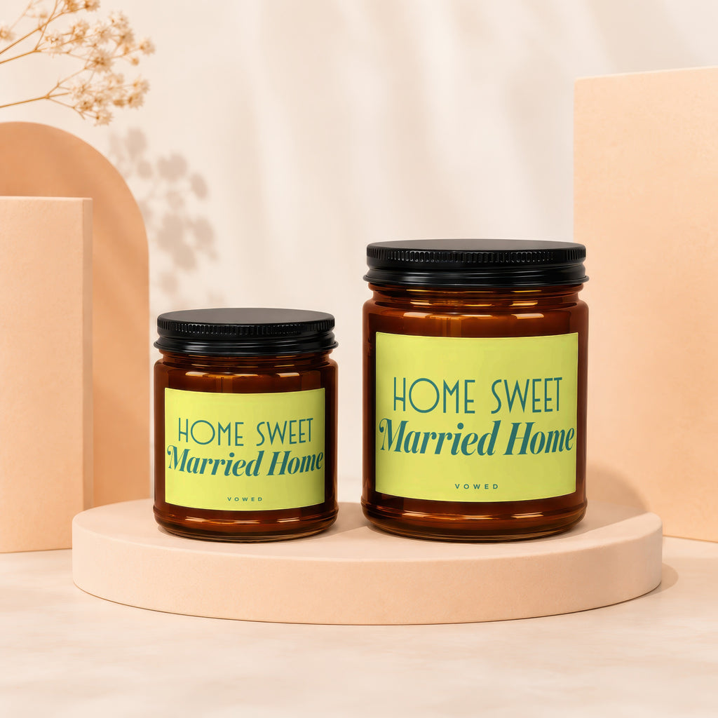 Two brown glass candles with black lids, labeled "HOME SWEET Married Home".
