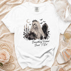 White t-shirt with a skeleton bride graphic and "Something Wicked Said 'I Do'".