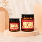 Two brown glass candles with red labels that read "Do Not Talk To Me About Seating Charts".
