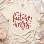 Future Mrs t-shirt with red script text and hearts, on a cream background.