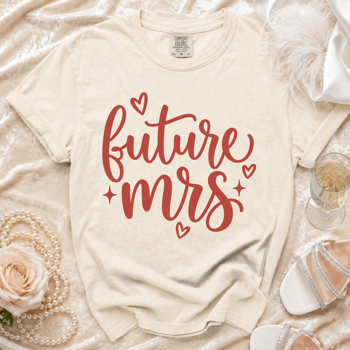 Future Mrs t-shirt with red script text and hearts, on a cream background.