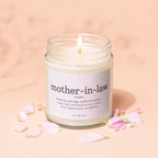 Glass candle with lit wick, labeled "mother-in-law noun".