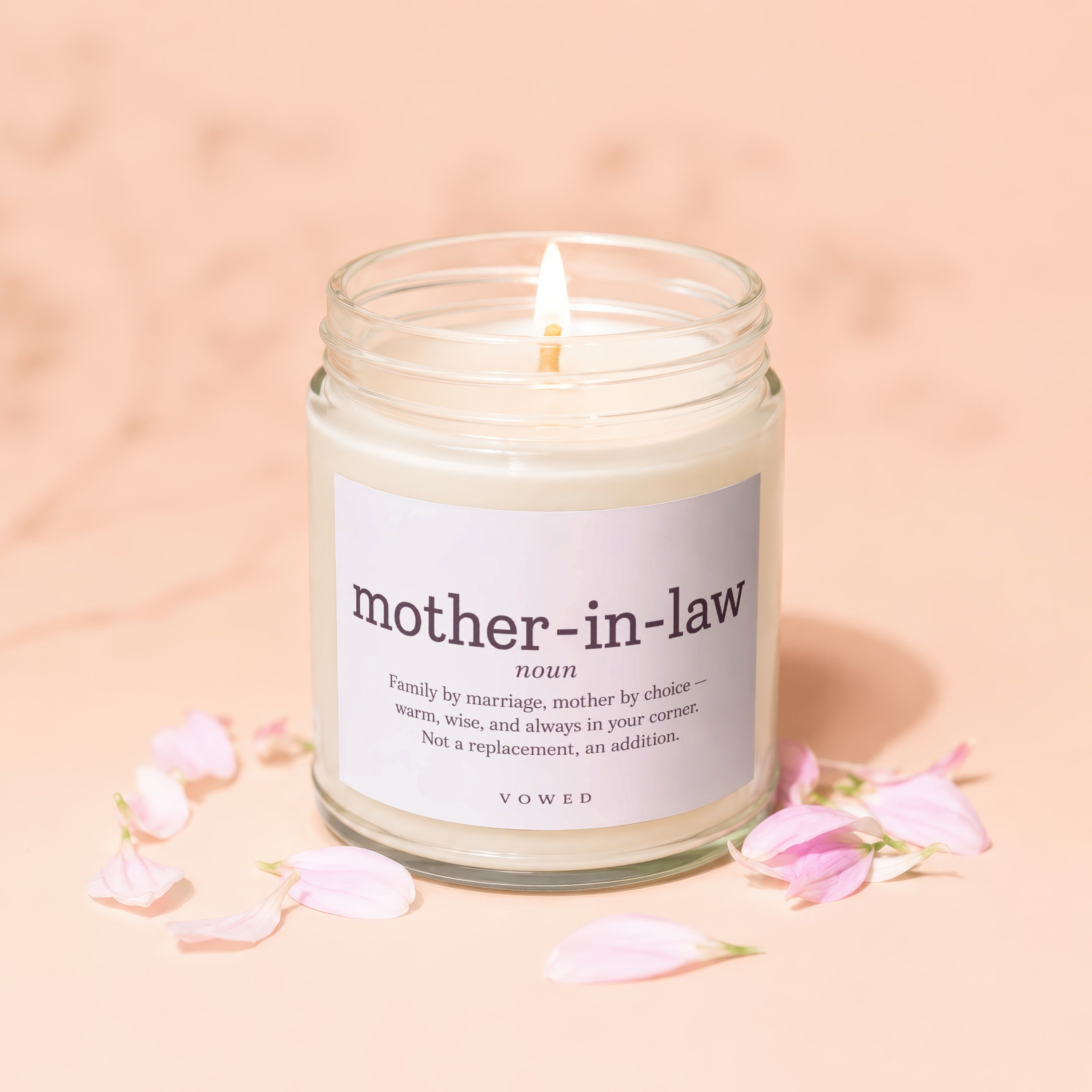 Glass candle with lit wick, labeled "mother-in-law noun".