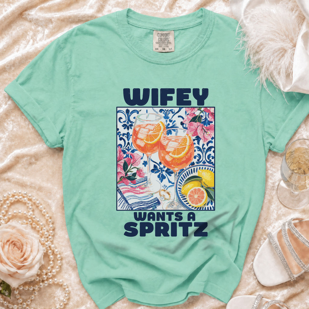 Mint green t-shirt with "Wifey Wants A Spritz" text and beverage graphic.