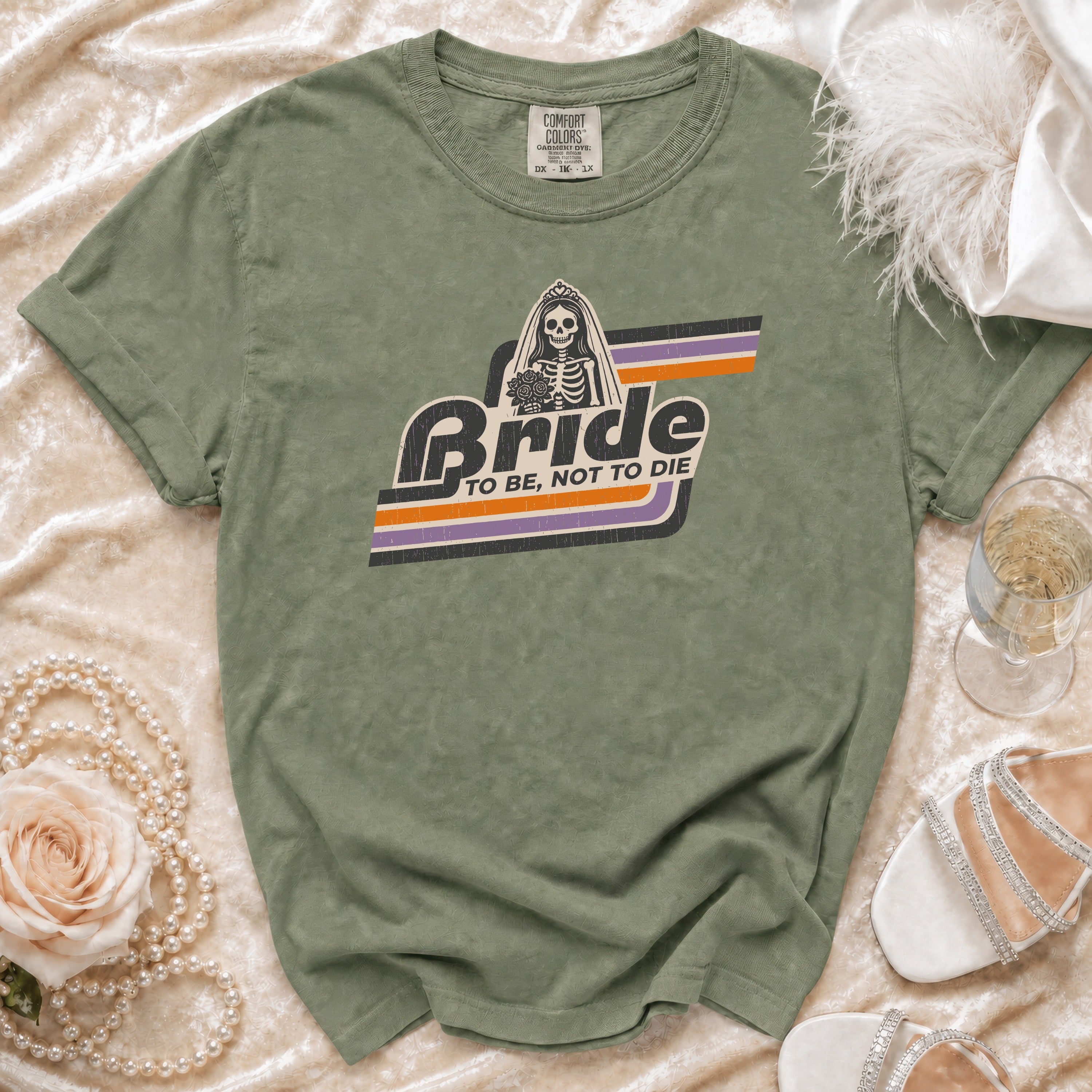 Olive t-shirt with "Bride To Be, Not To Die" skeleton graphic.