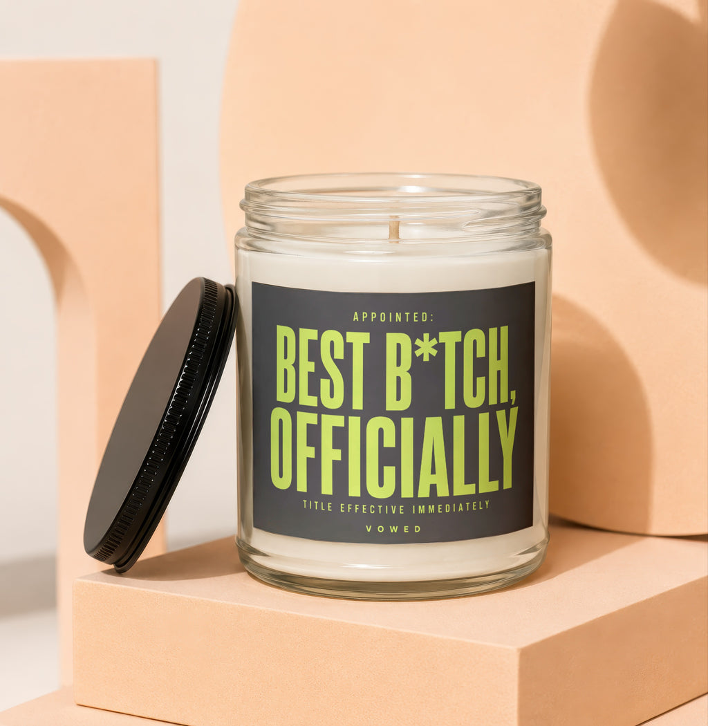 Glass jar candle with black lid, reading "Appointed: Best B*tch, Officially".