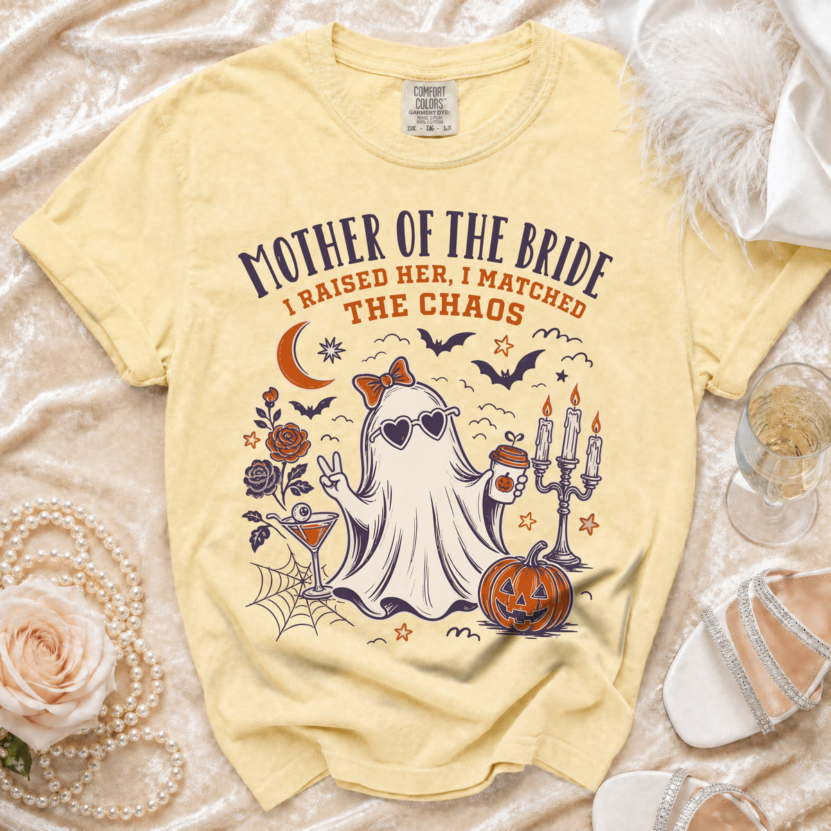 Yellow t-shirt with "Mother of the Bride" graphic of a ghost, pumpkin, and cocktail.