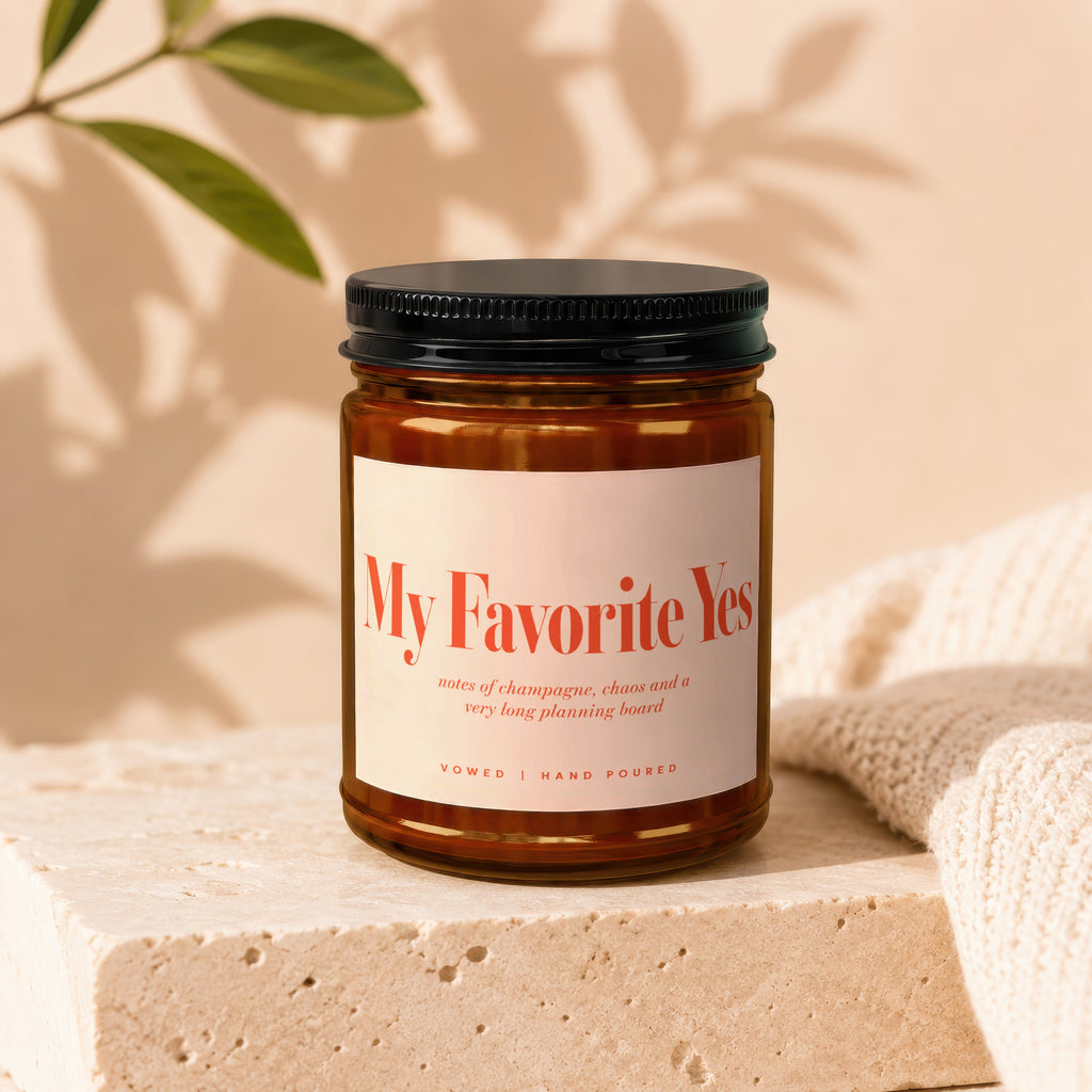 Amber jar candle titled "My Favorite Yes" with scent notes and "Vowed | Hand Poured".