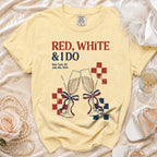 Light yellow t-shirt with "RED, WHITE & IDO" and New York, July 4, 2026 graphic.