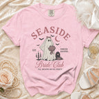 Pink t-shirt with "Seaside Bride Club" ghost bride graphic and "Til Death Do Us Party" text.