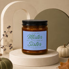 Candle with text "I found my Mister but I still need my Sister" on blue label.
