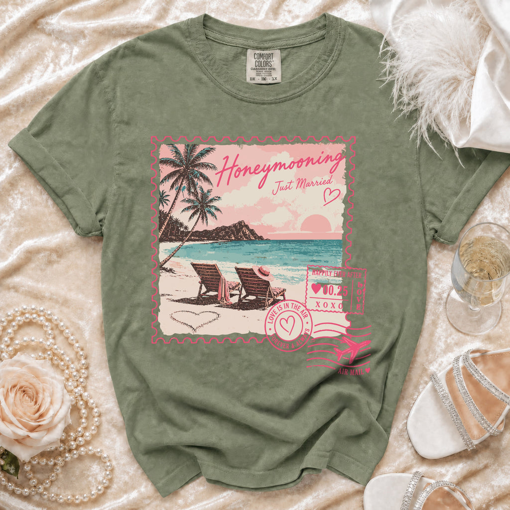 Olive green t-shirt with "Honeymooning Just Married" floral beach stamp graphic.