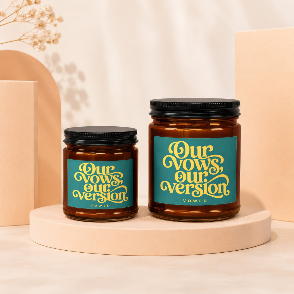Amber glass jar candle with teal label reading "Our Vows, Our Version"