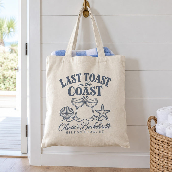 Last Toast On The Coast canvas tote hanging on a hook in a beach house