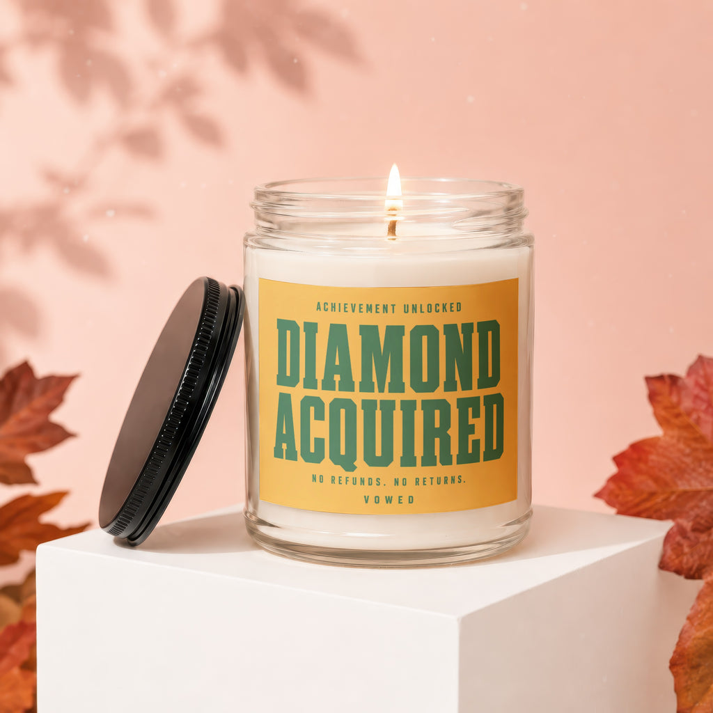 Scented candle with "Achievement Unlocked Diamond Acquired" text, no refunds, no returns, Vowed.