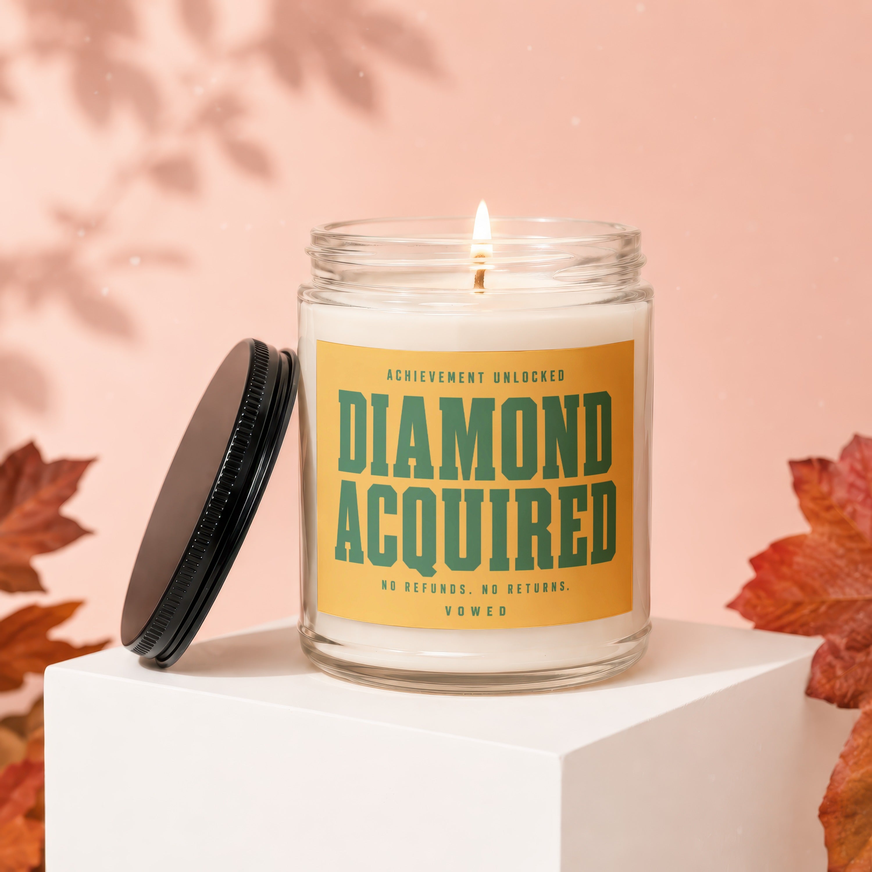 Scented candle with "Achievement Unlocked Diamond Acquired" text, no refunds, no returns, Vowed.