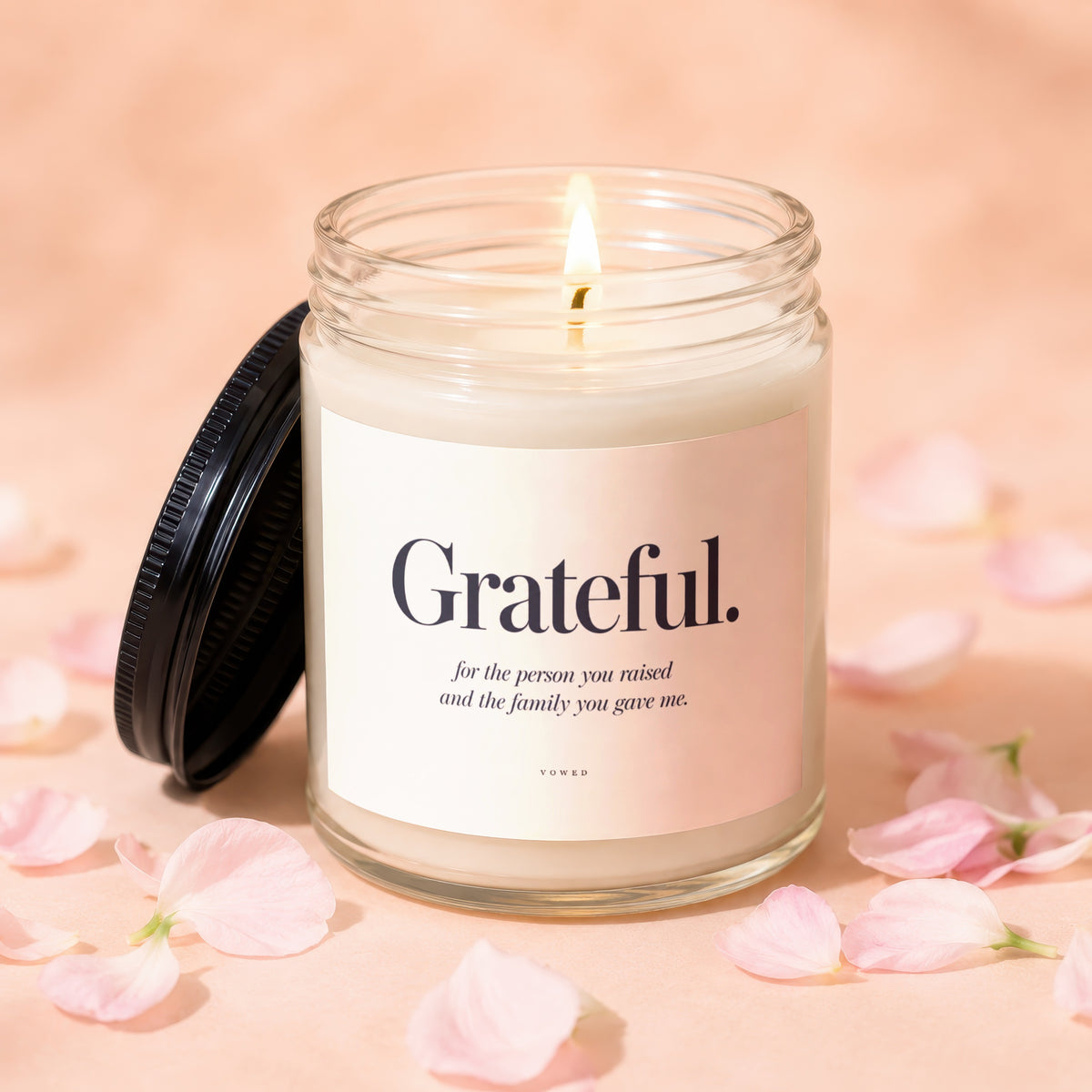 Grateful candle with text "for the person you raised and the family you gave me."