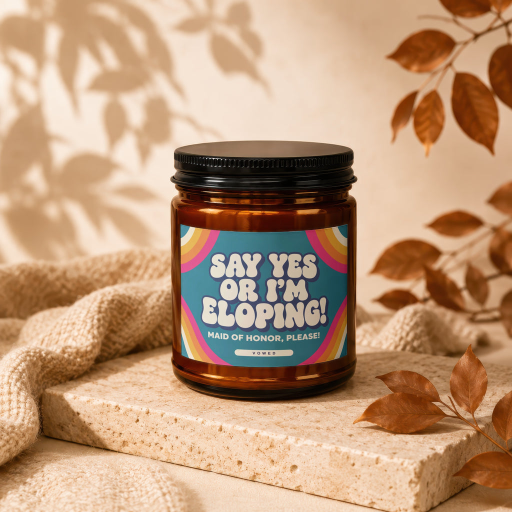 Candle with "Say Yes or I'm Eloping! Maid of Honor, Please!" text and rainbow detail.