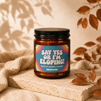 Candle with "Say Yes or I'm Eloping! Maid of Honor, Please!" text and rainbow detail.