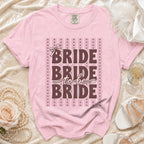 Pink t-shirt with "BRIDE to be BRIDE" text and bow detail.