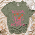 Olive green t-shirt with pink text "This Bride Needs a Negroni" and cocktail graphic.