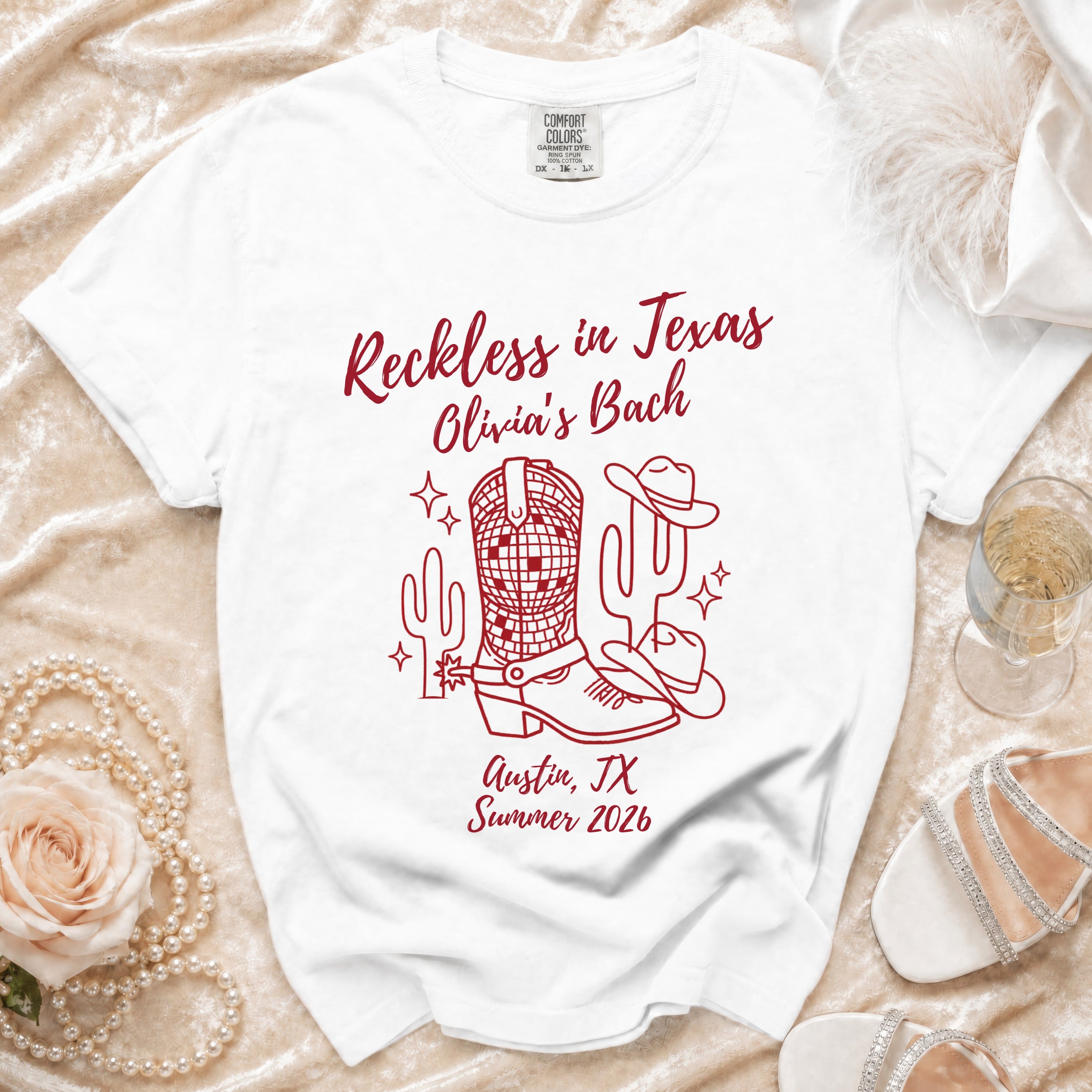 White t-shirt with "Reckless in Texas Olivia's Bach Austin, TX Summer 2026" in red.