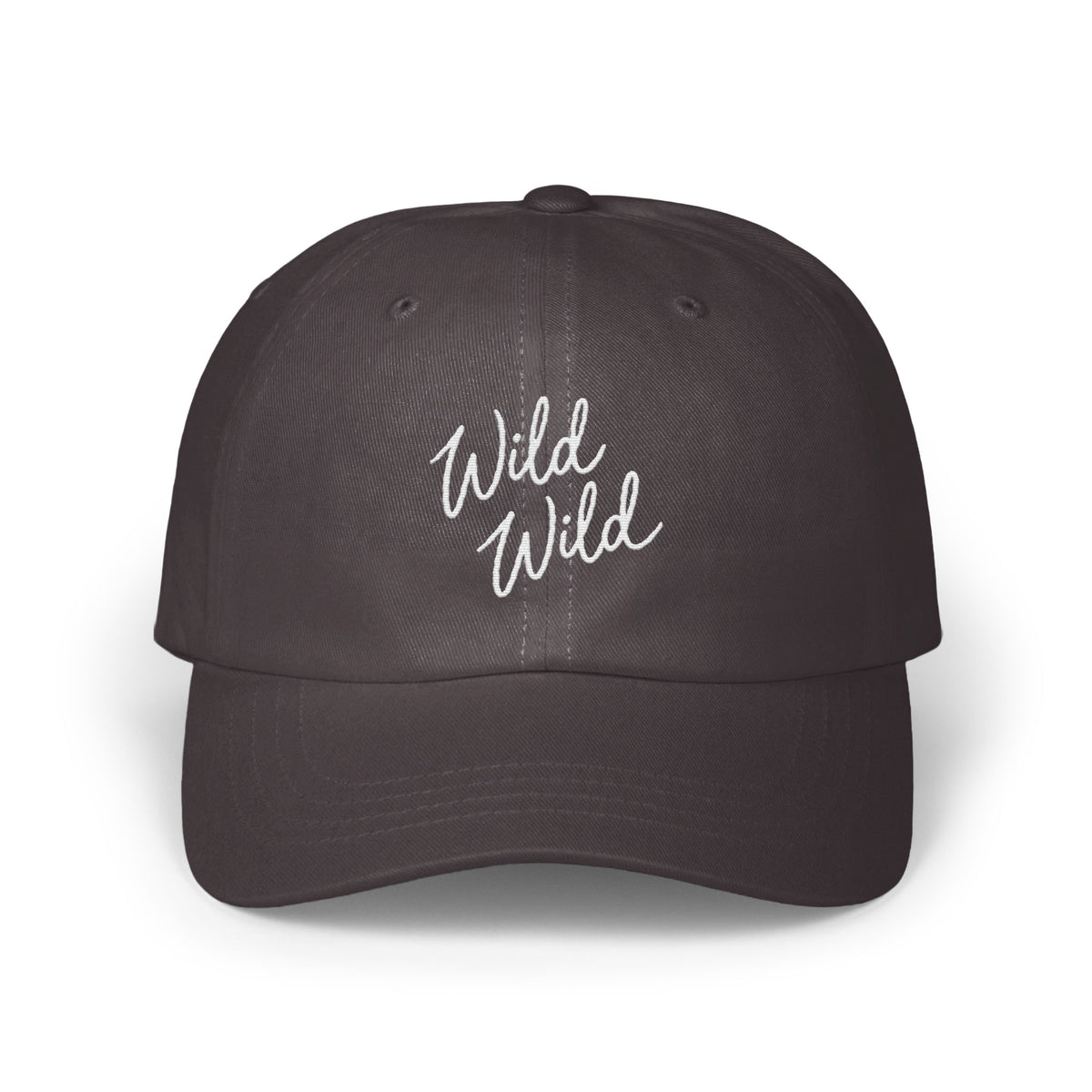 A dark charcoal baseball cap featuring the embroidered white text Wild Wild centered on the front panels.